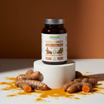 Butelka suplementu Kurkuma C3 Complex+ Biowen 60 kapsułek z korzeniami kurkumy i proszkiem na białym postumencie.