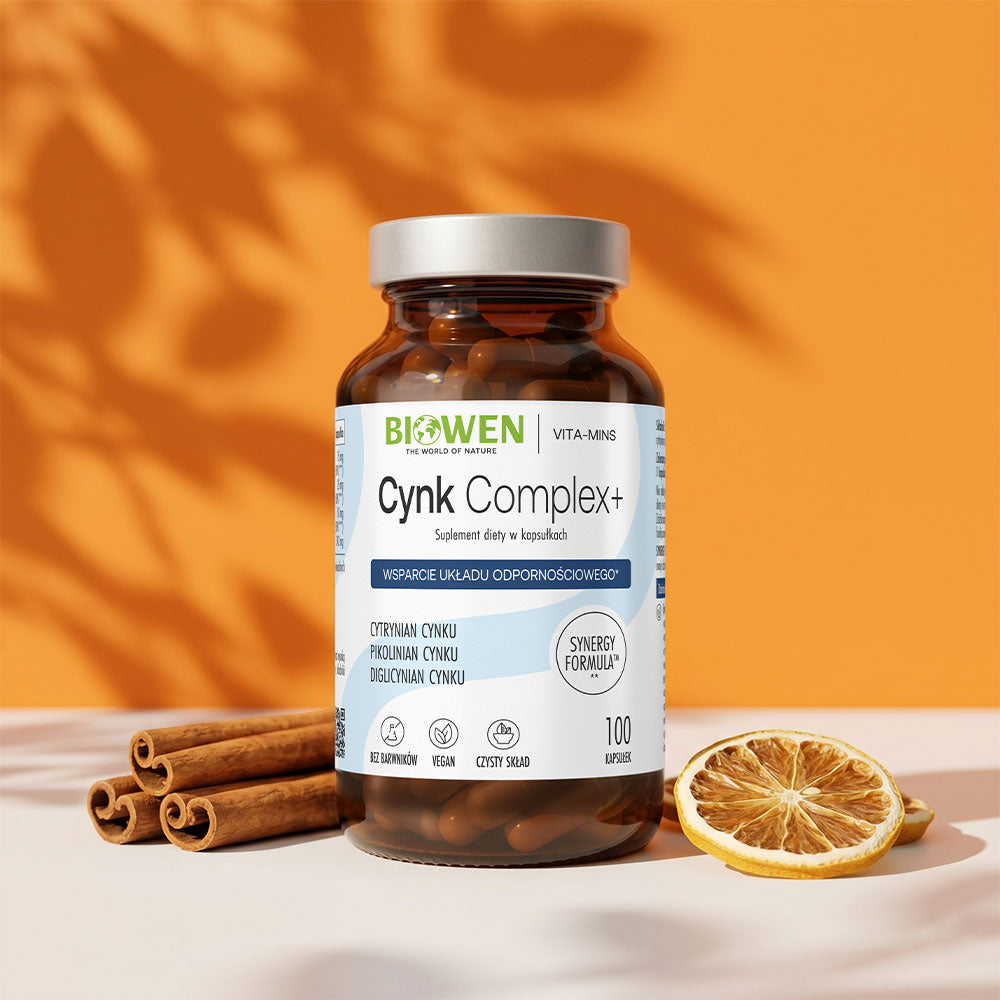 Suplement Cynk Complex+ Biowen na pomarańczowym tle z laskami cynamonu i suszoną cytryną