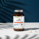 Opakowanie Treonian magnezu Magtein® Biowen 2000 mg z kapsułkami na jasnej powierzchni na tle niebieskiego tła